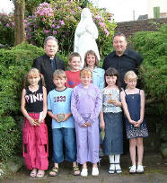 Bishop Taylor and Fr. Jim Hayes with children.
