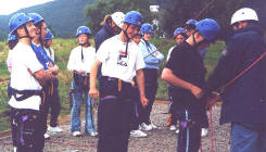 Wallclimbers get into protective gear before facing the incline