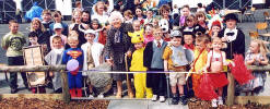 Former head teacher Margaret Murray cuts a ribbon to open the garden party and signal the start of an afternoon of fun.