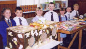 All smiles:pupils at the book stall ready to make a volume of sales