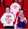 Caitlin and Louisa Davidson happily pose for a photo with Santa on the stage at Maybole Town Hall