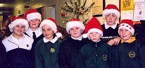 Pupils get into the Christmas spirit, wearing Santa hats as they get ready for their concert