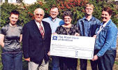 Jean Mackie (centre) and her family present a cheque for 600 to Jim Brodie, appeals director of the Ayrshire Hospice