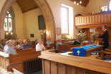 Rev Gerald Jones talking to some of the pilgrims in his church in Straiton